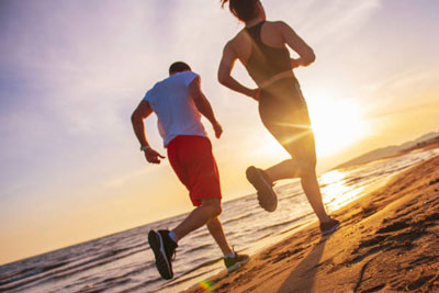 Sports jogging along the coast of the tropical sea